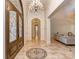 Grand foyer with a chandelier, elegant tile flooring, and a decorative front door at 235 Blue River Rd, Clover, SC 29710