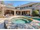 Luxury backyard with a stone patio, covered outdoor kitchen and dining space with a large hot tub at 235 Blue River Rd, Clover, SC 29710