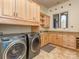 Well-lit laundry room with built-in cabinets, folding counter, sink, and modern washer and dryer at 235 Blue River Rd, Clover, SC 29710