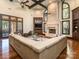 Bright living room featuring coffered ceilings, a grand stone fireplace, and expansive windows with wooded views at 235 Blue River Rd, Clover, SC 29710