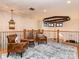 Comfortable loft with hardwood floors, iron railing, two chairs, and stylish overhead lighting at 235 Blue River Rd, Clover, SC 29710