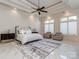 Bright primary bedroom featuring tray ceilings, a ceiling fan, and large windows with natural light at 235 Blue River Rd, Clover, SC 29710