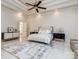 Spacious main bedroom featuring a ceiling fan, white walls, and a large rug over tile flooring at 235 Blue River Rd, Clover, SC 29710