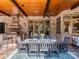 Covered outdoor dining area with an outdoor kitchen and stone patio at 235 Blue River Rd, Clover, SC 29710