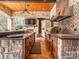 Covered outdoor kitchen featuring stainless steel appliances, granite countertops, and wooden ceiling at 235 Blue River Rd, Clover, SC 29710