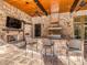 Covered outdoor kitchen with pizza oven, TV, stainless steel grill, and counter seating at 235 Blue River Rd, Clover, SC 29710