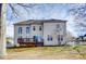 View of the back of the home with a wooden deck and access to the yard, perfect for outdoor entertaining at 2689 Wingrave Nw St, Concord, NC 28027