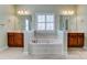 Bathroom features a bathtub between two vanities with dark wood cabinets and a neutral tile floor at 2689 Wingrave Nw St, Concord, NC 28027