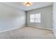 Neutral bedroom with a large window, providing natural light, and a simple, inviting space at 2689 Wingrave Nw St, Concord, NC 28027