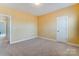 Bedroom with carpeted floors and neutral paint, with an en suite bathroom at 2689 Wingrave Nw St, Concord, NC 28027