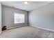 Bright bedroom with neutral walls and carpet, and a large window letting in natural light at 2689 Wingrave Nw St, Concord, NC 28027