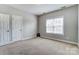 Cozy bedroom featuring neutral walls, carpet, a window, and two closets for ample storage at 2689 Wingrave Nw St, Concord, NC 28027