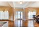 Elegant entryway featuring hardwood floors, decorative columns, and a glass-paneled front door at 2689 Wingrave Nw St, Concord, NC 28027
