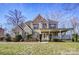 Charming brick home featuring a welcoming front porch and manicured landscaping at 2689 Wingrave Nw St, Concord, NC 28027