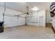Two car garage with side storage shelving and bright lighting perfect for vehicles and projects at 2689 Wingrave Nw St, Concord, NC 28027