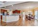 A spacious kitchen featuring dark wood cabinetry, granite countertops, and stainless steel appliances open to the dining area at 2689 Wingrave Nw St, Concord, NC 28027