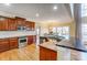 A warm kitchen boasting stainless steel appliances, granite countertops, and wooden cabinetry leading to the dining room at 2689 Wingrave Nw St, Concord, NC 28027