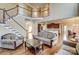 Open-concept living space with hardwood floors, a staircase, and kitchen access at 2689 Wingrave Nw St, Concord, NC 28027