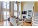 Bright living room with tall windows, fireplace, and built-in shelving at 2689 Wingrave Nw St, Concord, NC 28027