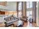 Bright, open living room featuring hardwood floors, tall windows, and a partial view of dining area at 2689 Wingrave Nw St, Concord, NC 28027