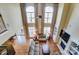 An aerial view of a living room showcasing tall windows, hardwood floors, comfortable seating, and a cozy fireplace at 2689 Wingrave Nw St, Concord, NC 28027
