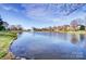 Beautiful community pond view showcasing a peaceful setting and lush greenery at 2689 Wingrave Nw St, Concord, NC 28027