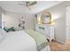 Well-lit bedroom features a white dresser, decorative shelving, and comfortable neutral decor at 2727 Tiergarten Ln, Charlotte, NC 28210