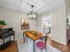 Inviting dining room with unique table and chairs, complemented by hardwood floors and modern light fixture at 2727 Tiergarten Ln, Charlotte, NC 28210