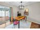 Modern dining area with stylish light fixture and sliding glass doors to the patio for outdoor entertaining at 2727 Tiergarten Ln, Charlotte, NC 28210