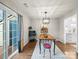 Bright dining room features hardwood floors, modern lighting, and sliding glass doors to the exterior at 2727 Tiergarten Ln, Charlotte, NC 28210