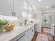 Bright kitchen features shaker cabinets, speckled quartz counters, and a stylish mosaic backsplash at 2727 Tiergarten Ln, Charlotte, NC 28210