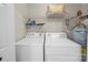 Convenient laundry room includes a washer, dryer, and storage shelves for organization at 2727 Tiergarten Ln, Charlotte, NC 28210