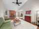 Open-concept living room featuring vaulted ceilings, brick fireplace, and contemporary furnishings at 2727 Tiergarten Ln, Charlotte, NC 28210