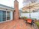 Relaxing patio area with brick pavers, outdoor seating, and partial view of the home's exterior at 2727 Tiergarten Ln, Charlotte, NC 28210