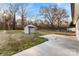 Spacious backyard featuring a storage shed, concrete patio, and mature trees at 2729 Springbrook Cir, Gastonia, NC 28052