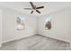 Sunlit bedroom featuring neutral walls, new flooring, and a ceiling fan, offering a cozy and inviting atmosphere at 2729 Springbrook Cir, Gastonia, NC 28052