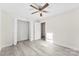 Bright bedroom features a ceiling fan, closet, and light gray wood-look flooring at 2729 Springbrook Cir, Gastonia, NC 28052