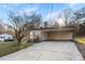Single story home with gray brick, a concrete driveway, carport and new wood porch at 2729 Springbrook Cir, Gastonia, NC 28052