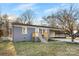 Charming single-story home with gray brick, a wooden porch, and mature landscaping at 2729 Springbrook Cir, Gastonia, NC 28052