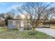 Cozy single-story home with gray brick, mature landscaping, and attached carport at 2729 Springbrook Cir, Gastonia, NC 28052