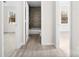 Bright hallway showcasing new flooring and doorways leading to various rooms, highlighting the home's layout at 2729 Springbrook Cir, Gastonia, NC 28052
