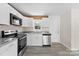 Modern kitchen features stainless appliances, granite countertops, and bright white cabinets at 2729 Springbrook Cir, Gastonia, NC 28052