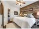 Cozy bedroom featuring a wood wall, bed and decor, leading to additional rooms at 2745 Bonnybrook Cir, Rock Hill, SC 29732