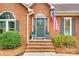 Charming brick home entrance featuring a wreath-adorned door and manicured landscaping at 2745 Bonnybrook Cir, Rock Hill, SC 29732