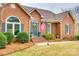 Charming brick home featuring manicured landscaping, an inviting front door, and an American flag at 2745 Bonnybrook Cir, Rock Hill, SC 29732
