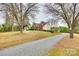 Traditional brick and siding home with an inviting front yard and a long, gravel driveway at 2745 Bonnybrook Cir, Rock Hill, SC 29732