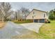 Spacious two-car garage with ample parking space, surrounded by trees and gravel driveway at 2745 Bonnybrook Cir, Rock Hill, SC 29732