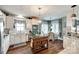 Well-lit kitchen features white cabinets, stainless steel appliances, and a cozy breakfast nook at 2745 Bonnybrook Cir, Rock Hill, SC 29732