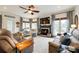 Bright and airy living room with cozy fireplace, large windows, ceiling fan, and stylish furnishings at 2745 Bonnybrook Cir, Rock Hill, SC 29732