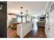 Open-concept living space with a kitchen island, hardwood floors, and a cozy living room area at 2745 Bonnybrook Cir, Rock Hill, SC 29732